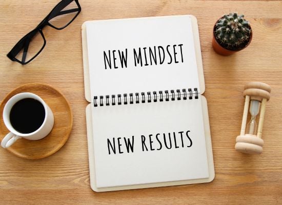 Notebook on desk that says New Mindset New Results