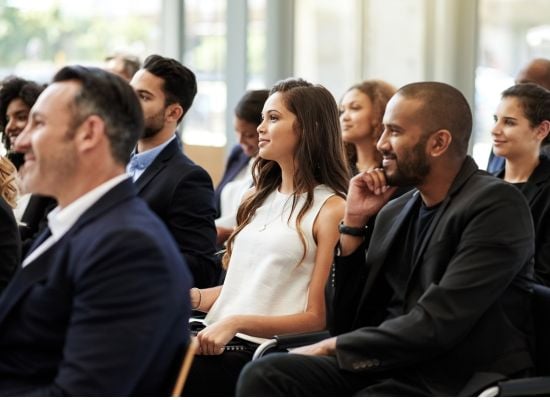 people sitting in conference session with interest