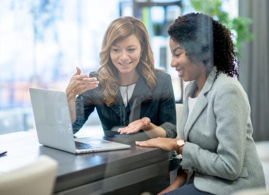 two women at laptop working two women at laptop working